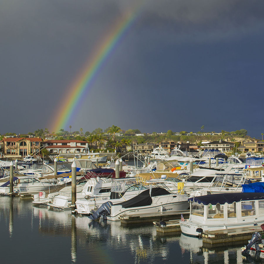 Newport Beach boat slips with rainbow behind